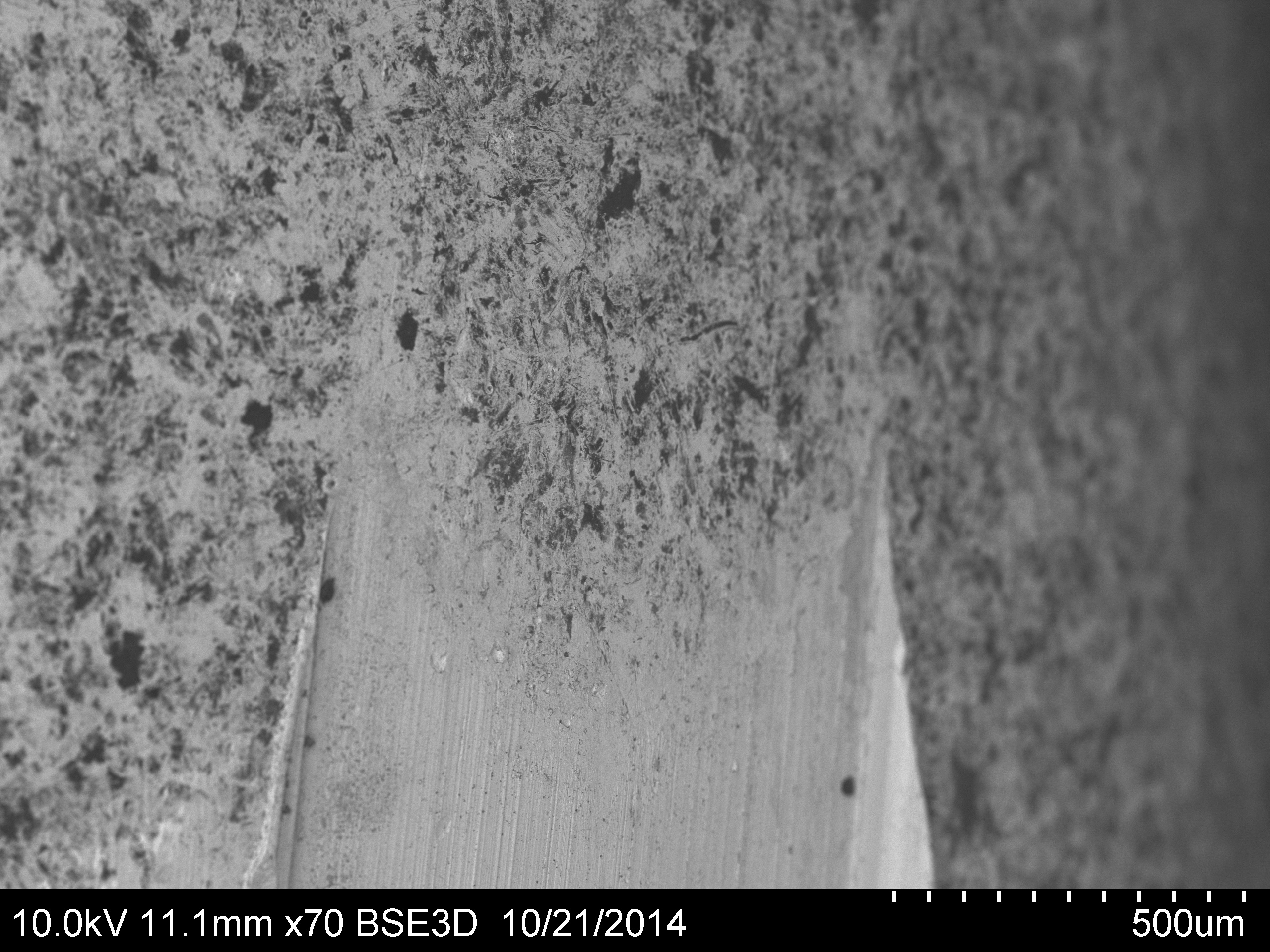 Micrograph of rifled engraving on a .30" copper-jacketed bullet that was impact-plated with hBN (which appears in black).